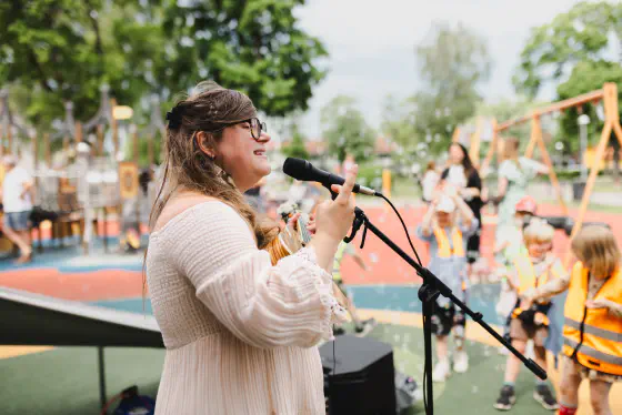 Emma håller en sångstund i en lekpark